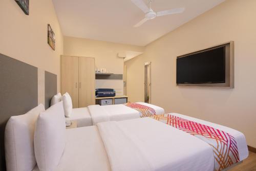 Una cama o camas en una habitación de Ginger Trivandrum