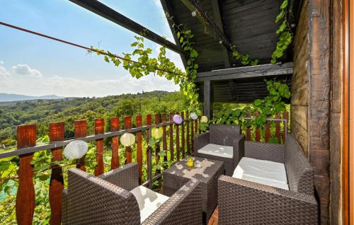 a patio with chairs and tables on a balcony at Cozy Home In Vukovoj With Wi-Fi in Vukovoj