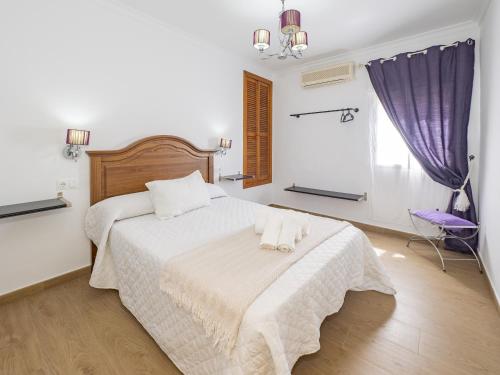a bedroom with a white bed with two pillows on it at Cubo's Casa Camino del Cantinero in Ardales