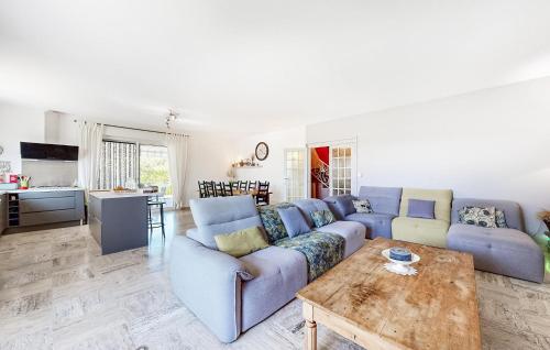 un salon avec un canapé bleu et une table dans l'établissement Cozy Home In Lamotte Du Rhone, à Lamotte-du-Rhône