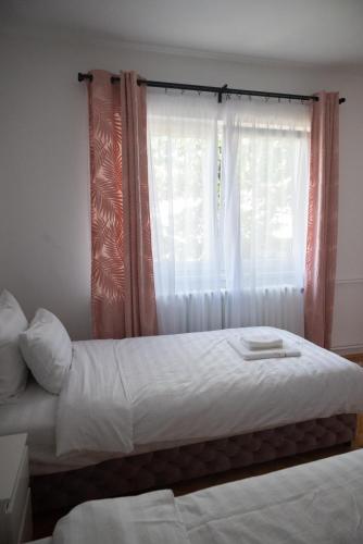 a bedroom with two beds and a window at M2-apartments in Kraljevo