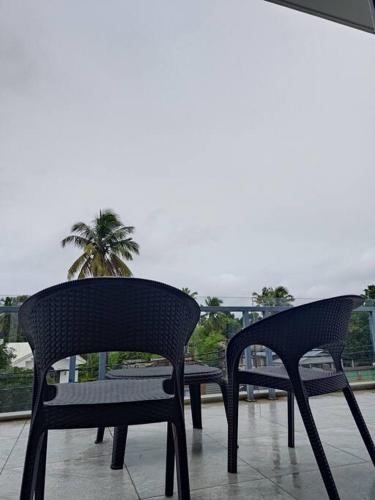 two chairs sitting on top of a balcony at Great Stays - WFH in Central Alleppey in Alleppey