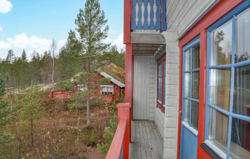 a house with a wooden porch and a window at Stunning Apartment In Sälen With Sauna in Sälen