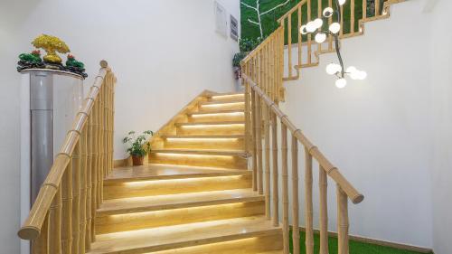 a wooden staircase in a home with wooden floors at Dashe Yuanye Boutique Homestay in Xitang