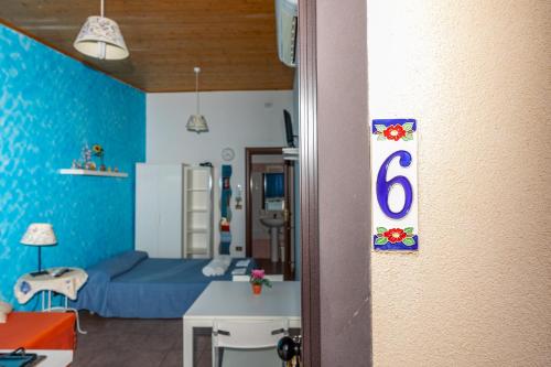 a room with a blue room with a bed and a table at Antica Dimora Marinelli in Ficarra