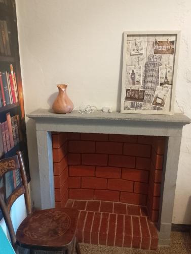 a brick fireplace with a vase sitting on top of it at La Vista Sul Castello in Compiano