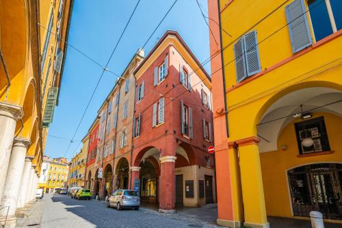 a group of buildings on a city street at Casa delle Note in Modena