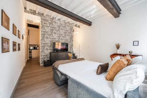 a bedroom with a large bed and a television at Casa delle Note in Modena