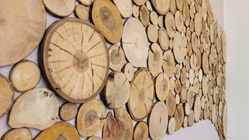 a bunch of wood slices on a wall at Private & Comfortable Apartments in Puttelange-aux-Lacs