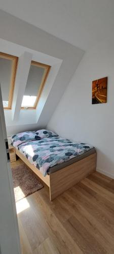 a bedroom with a bed in a attic at Garden Baltic in Trzęsacz