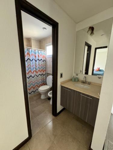 a bathroom with a sink and a toilet and a mirror at Duplex para 5 personas t4 in Guaymallen