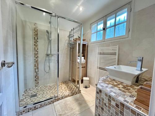a bathroom with a shower and a tub and a sink at Seaview Villa Petit Prince, Pool, air conditioning in Sainte-Maxime