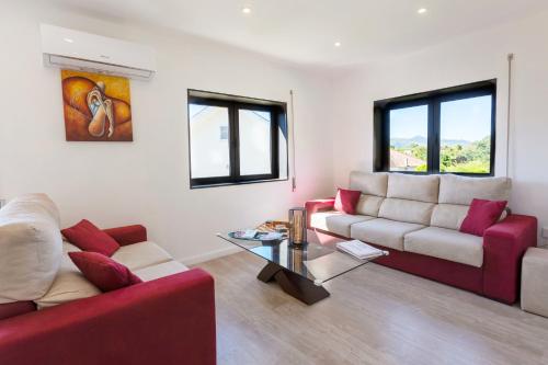 a living room with two couches and a table at Casa de Clarisse in Ermelo