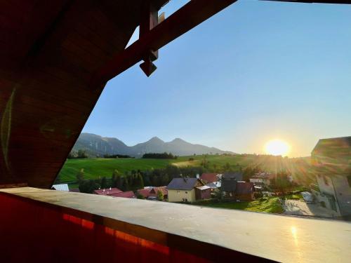 a view from a window of a town with the sunset at Chalupa Beliankovo Ždiar in Ždiar