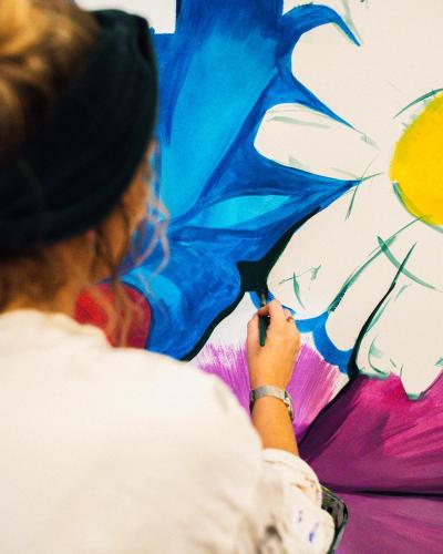 a woman is holding a painting of an umbrella at INNSiDE by Meliá Manchester in Manchester