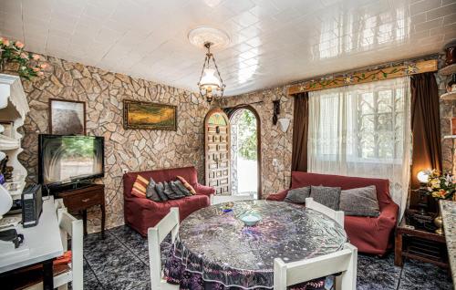 a living room with a table and a couch at 2 Bedroom Cozy Apartment In Vidreres in Vidreres