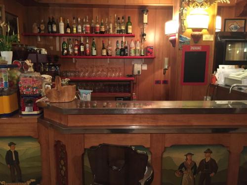 a bar in a restaurant with a counter top at Hotel Tosa in Madonna di Campiglio
