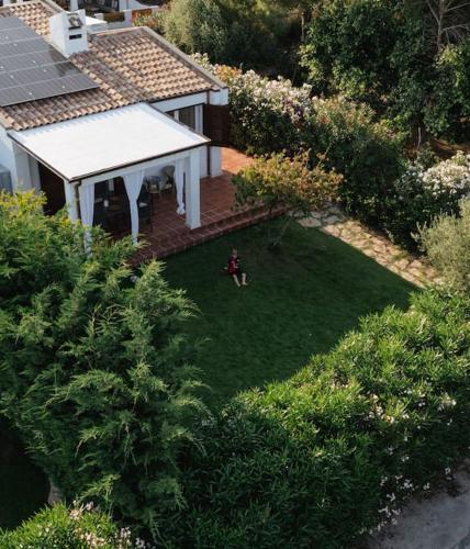 an aerial view of a yard with a person sitting in the grass at Villa Costarei minipiscina in Costa Rei