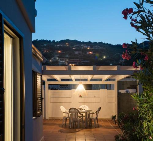 a patio with a table and chairs on a balcony at Villa Costarei minipiscina in Costa Rei