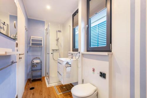 a bathroom with a toilet and a window at Hausboot Joana in Zehdenick