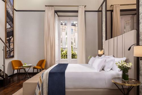 a hotel room with a bed and a window at NH Collection Madrid Palacio de Tepa in Madrid