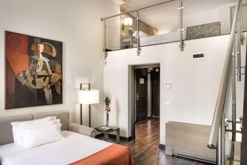 Ένα ή περισσότερα κρεβάτια σε δωμάτιο στο NH Collection Madrid Palacio de Tepa