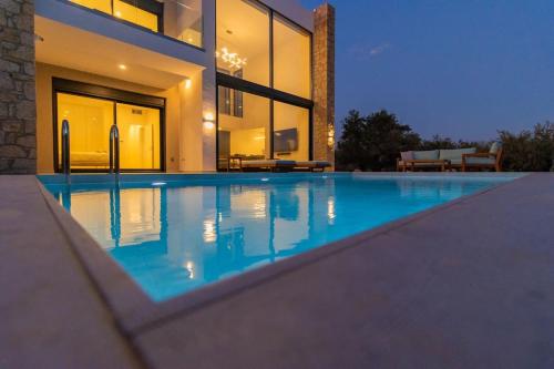 a large swimming pool in front of a house at Ocean View 1111 Retreat in Rikia