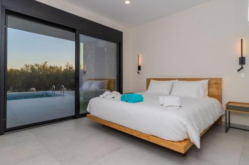 a bedroom with a large bed and a swimming pool at Ocean View 1111 Retreat in Rikia
