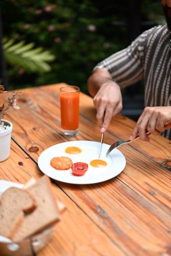 a person sitting at a table with a plate of food at The Park Kolkata in Kolkata