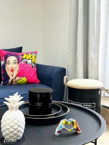 a living room with a blue couch and a table at PopLaon appartement avec terrasse in Laon