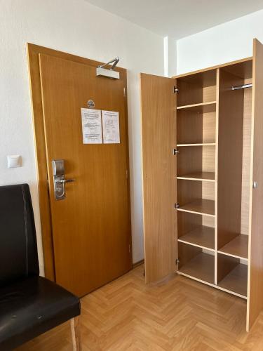 a room with a door and a closet at Hotel Muza in Košice