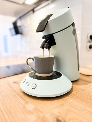 a coffee maker sitting on top of a table at NEW Élégance et Confort face à la gare Parking in Guingamp