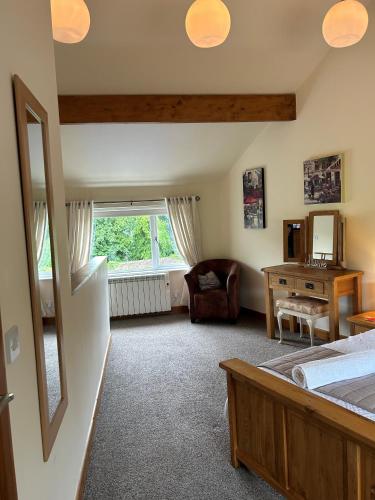 a bedroom with a bed and a desk and a window at Tar Top in Silsden