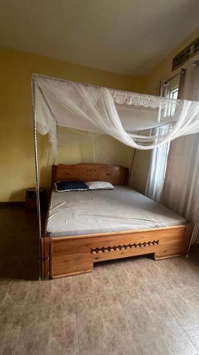 a bedroom with a bunk bed with a canopy at Kajaga Tanganyika in Bujumbura