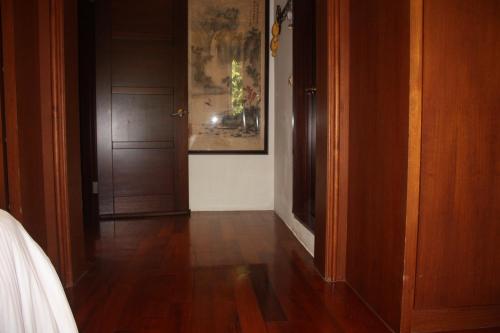 a hallway with a door and a painting on the wall at Phil Garden Homestay in Dongshan