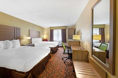 a hotel room with two beds and a desk at Best Western Rochester Marketplace Inn in Rochester