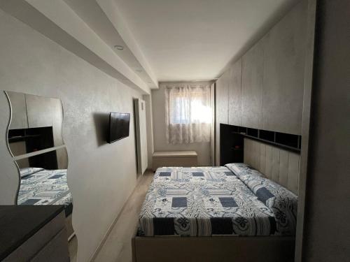 a small bedroom with two beds and a window at Domus Teresae in Avezzano