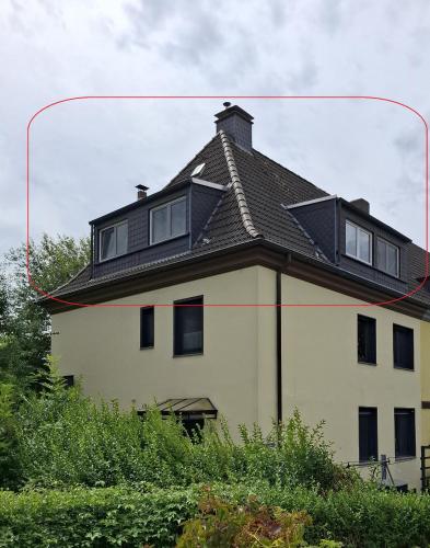 a house with a roof on top of it at Ferienwohnung am Stadion Bochum Grumme in Bochum