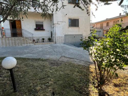 a large white house with a courtyard in front of it at Domus Teresae in Avezzano