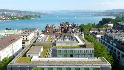 an aerial view of a city with a body of water at Park Hyatt Zurich – City Center Luxury in Zürich