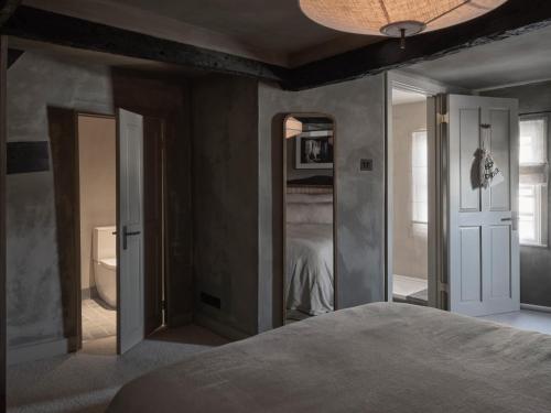a bedroom with a bed and a bathroom with a mirror at Highway in Burford