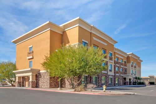 a large building with a tree in front of it at Comfort Suites Blythe in Blythe