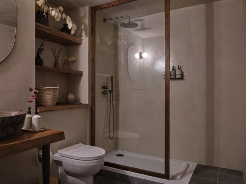 a bathroom with a shower and a toilet at Highway in Burford