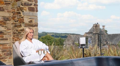 a woman sitting in a chair with a glass of wine at Boringdon Hall Hotel and Spa in Plymouth