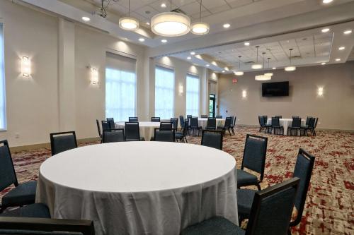 a conference room with a white table and chairs at Hilton Garden Inn Bel Air, Md in Bel Air