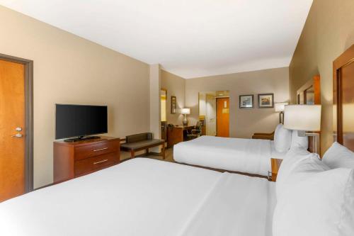 a hotel room with two beds and a flat screen tv at Comfort Inn & Suites Jerome - Twin Falls in Jerome