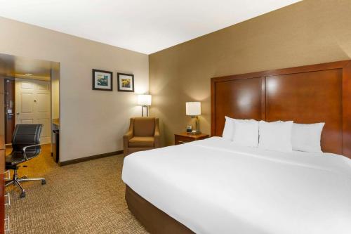 a hotel room with a large bed and a chair at Comfort Inn & Suites Jerome - Twin Falls in Jerome