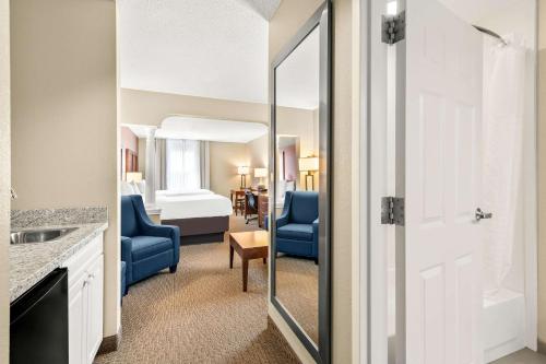 a bathroom with a mirror and a room with a bedroom at Comfort Inn & Suites North Conway in North Conway