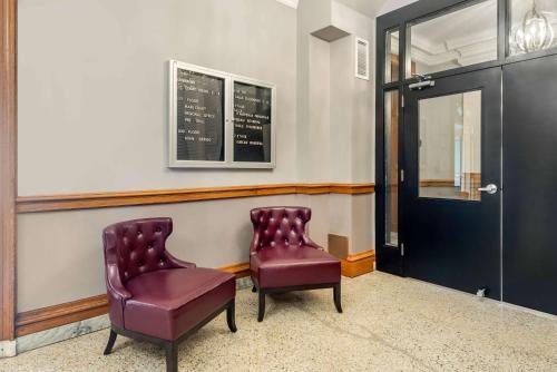 two purple chairs sitting in a waiting room at The Courthouse Hotel, an Ascend Collection Hotel in Thunder Bay