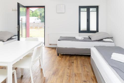 two beds in a room with a table and a desk at Z.Bilić V&V in Jesteburg